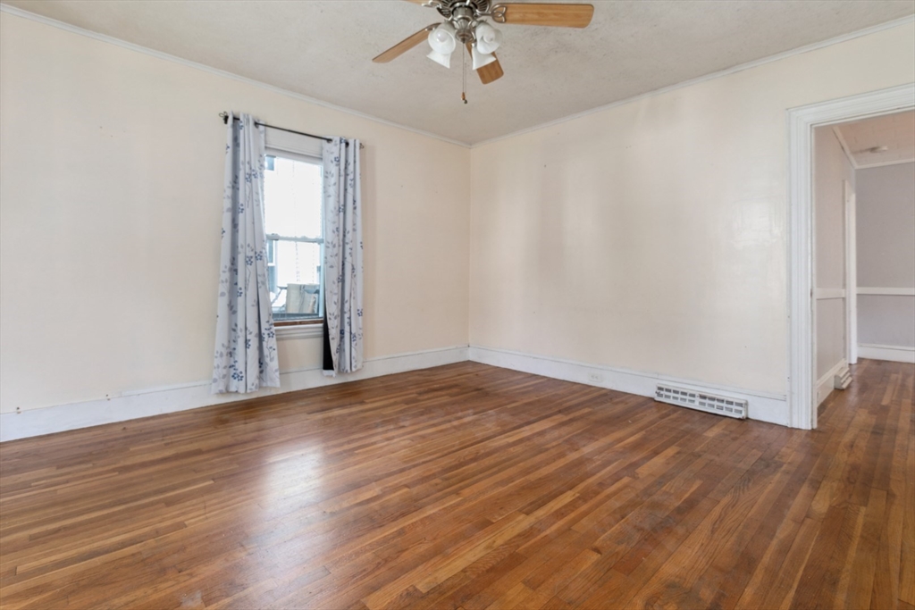 40 Village Street Reading, MA 01867 - Photo 6 of 36 wooden floor in an empty room with a window