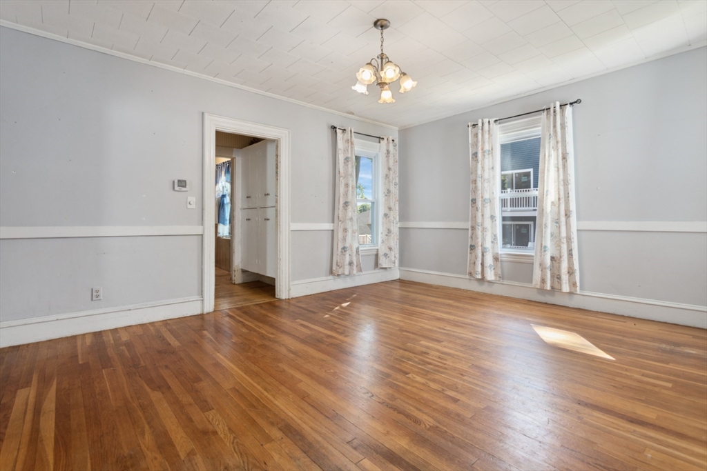 40 Village Street Reading, MA 01867 - Photo 8 of 36 a view of an empty room with wooden floor and a window