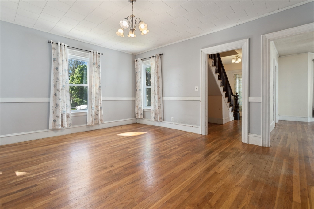 40 Village Street Reading, MA 01867 - Photo 9 of 36 a view of empty room with wooden floor and fan