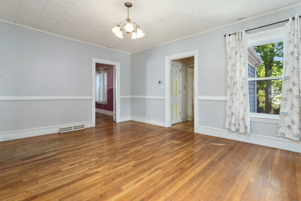 40 Village Street Reading, MA 01867 - Photo 10 of 36 a view of an empty room with wooden floor and a window