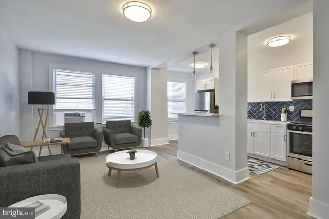 a kitchen with stainless steel appliances granite countertop a sink stove and microwave