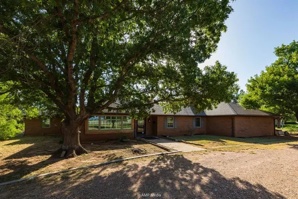 a front view of a house with a yard and a garage