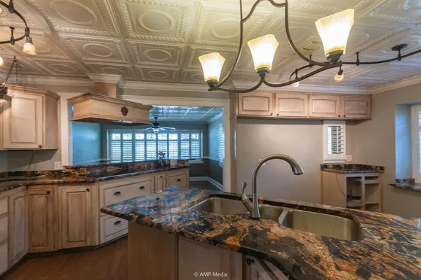 a kitchen with stainless steel appliances kitchen island granite countertop a stove and cabinets