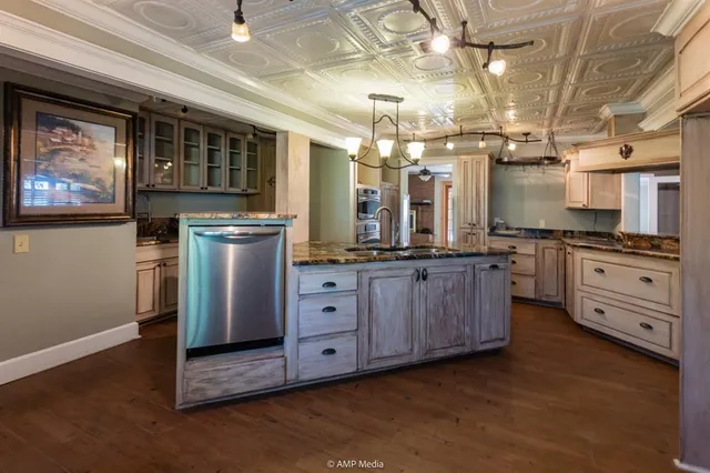 a kitchen with sink refrigerator and window