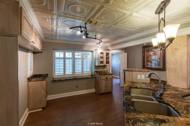 a kitchen with stainless steel appliances granite countertop a stove and cabinets