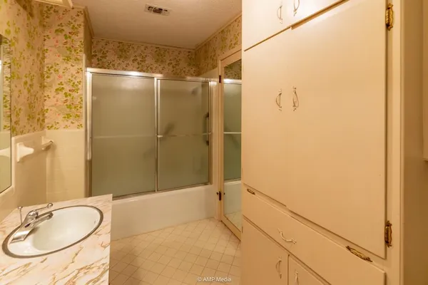 a bathroom with a toilet a sink and a mirror