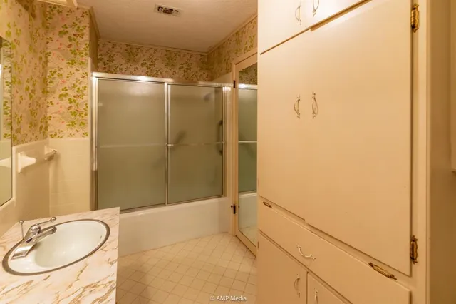 a bathroom with a toilet a sink and a mirror