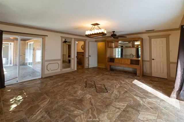 a dining room with furniture a chandelier window and wooden floor