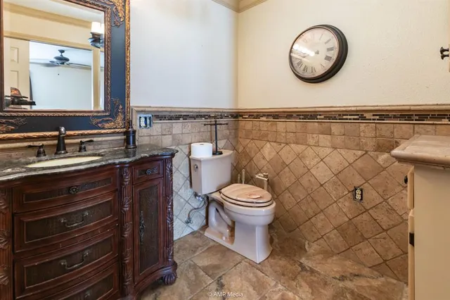 a living room with furniture a chandelier and a bookshelf
