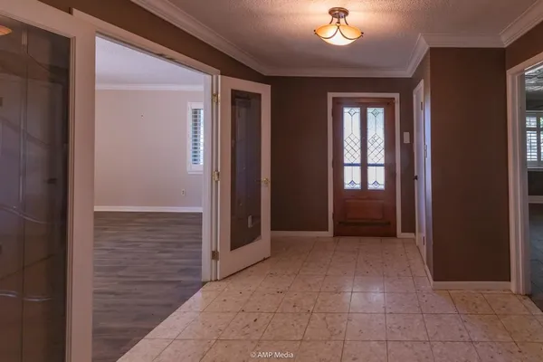 an entryway with wooden floor and cabinet