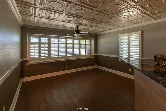 a view of a kitchen with furniture and wooden floor