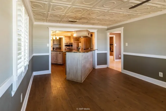 a kitchen with stainless steel appliances granite countertop a sink a stove and a wooden cabinets