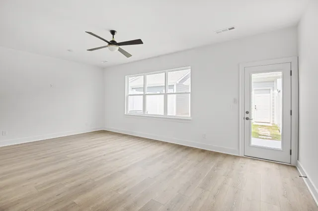a view of a kitchen with a sink and wooden floor