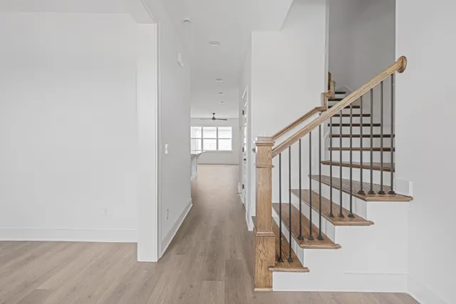 a view of staircase with white walls and a window