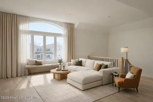 a bedroom with furniture and a large window
