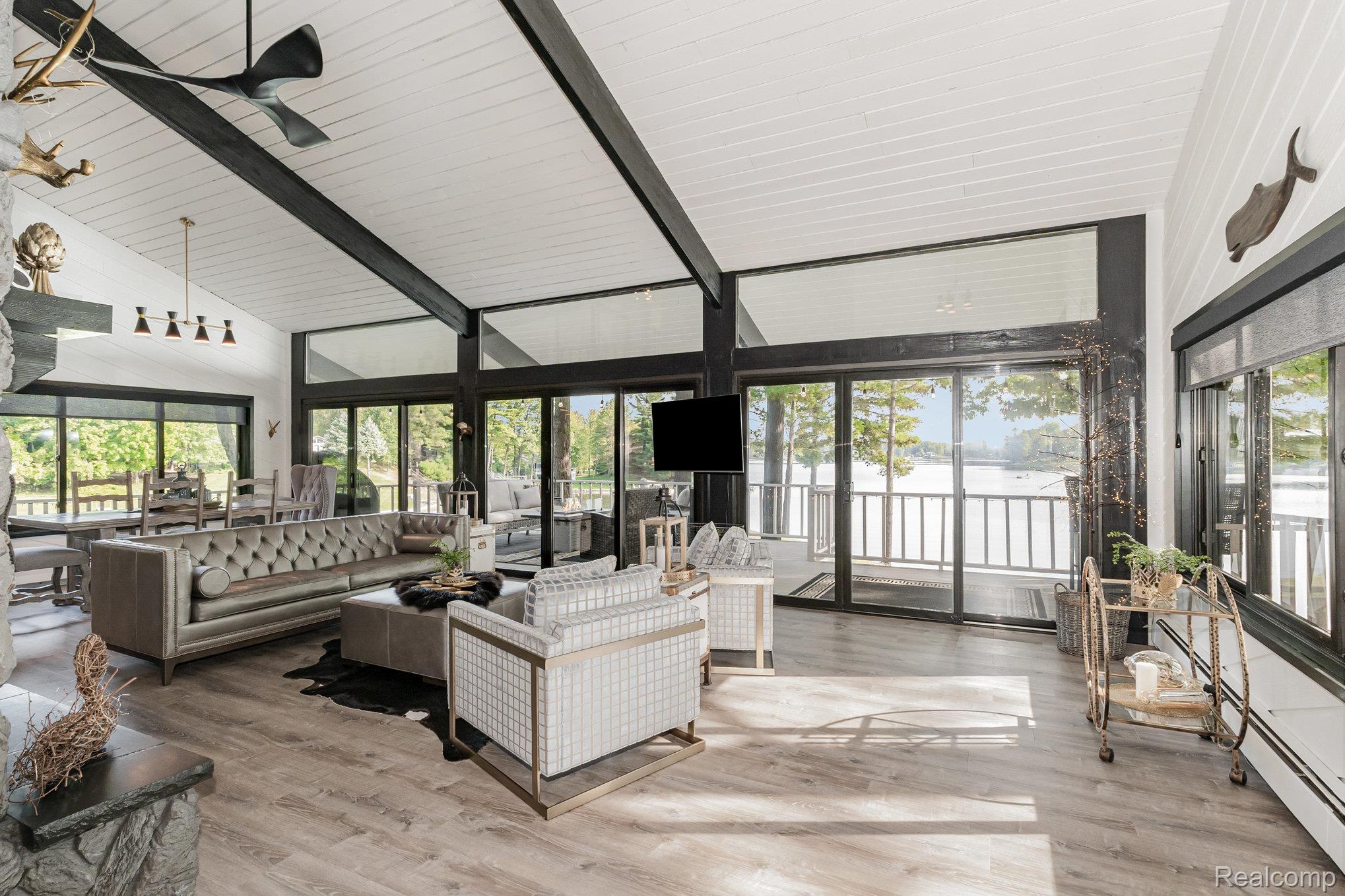 2380 Islanders Way Gladwin, MI 48624 - Photo 14 of 48 Sunroom with a baseboard radiator, an outdoor hangout area, vaulted ceiling with beams, and a ceiling fan