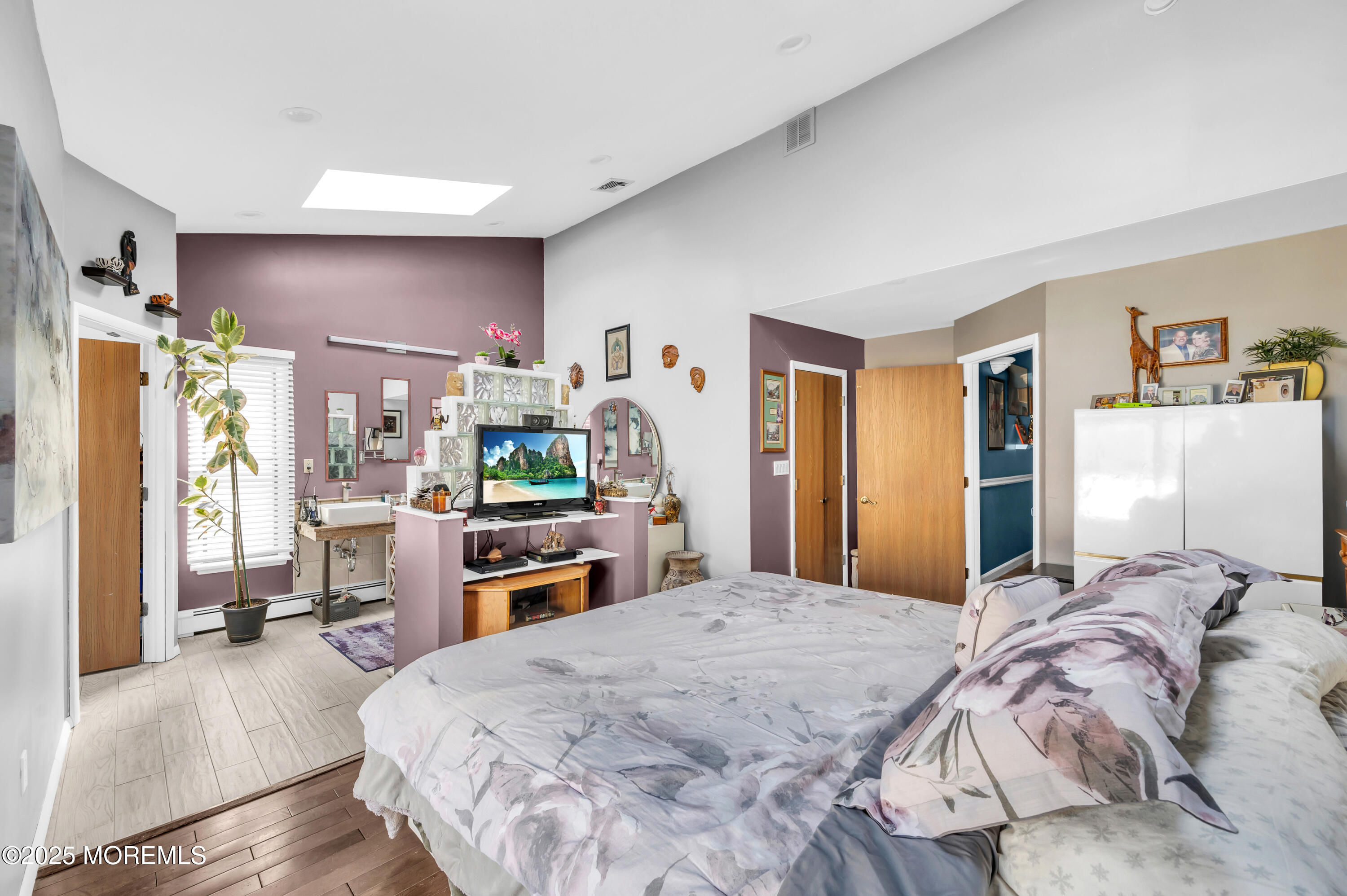 98 Bowman Road Jackson, NJ 08527 - Photo 41 of 61 a bedroom with a large bed and a flat tv screen on dresser