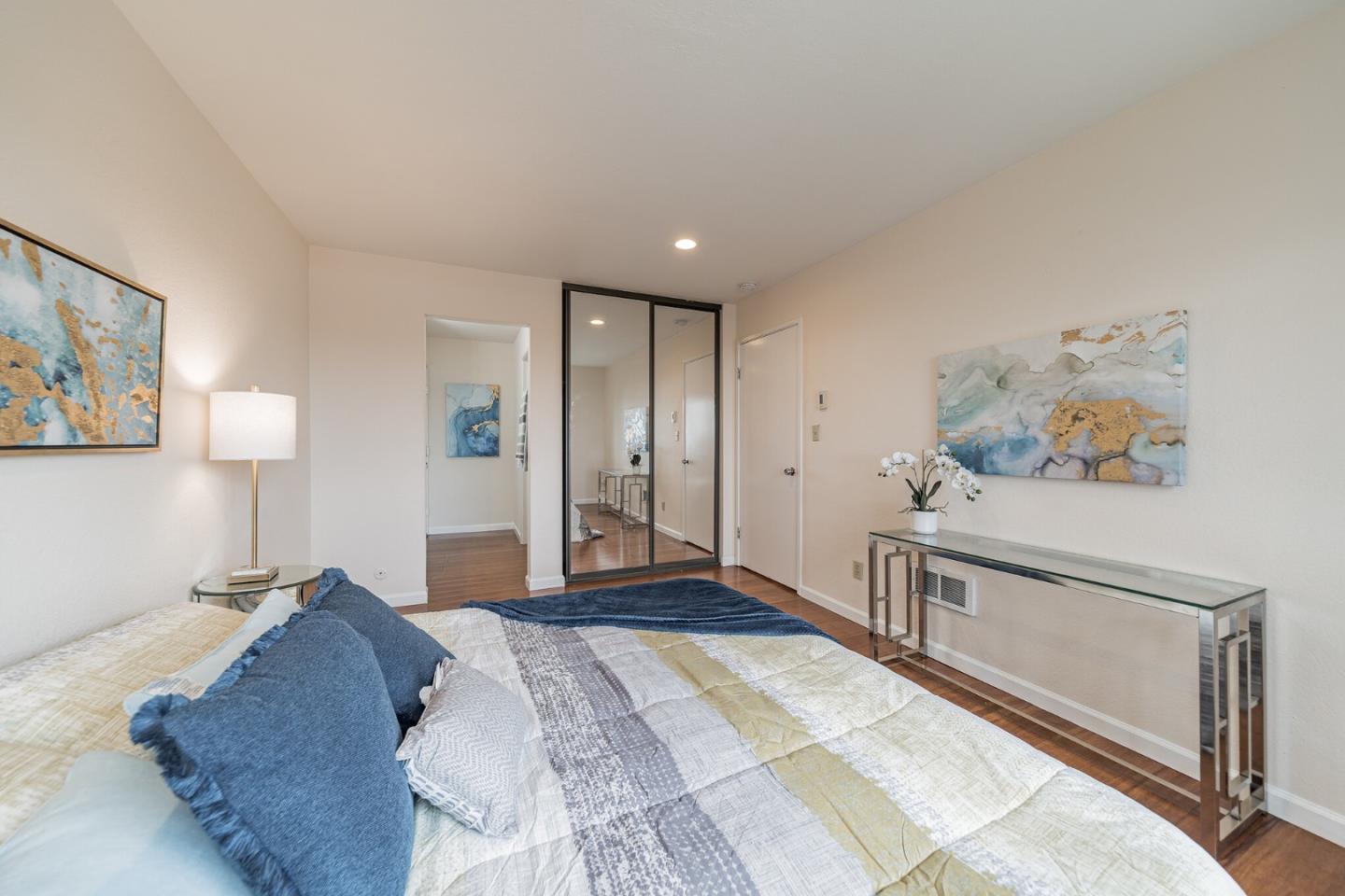 348 Innisfree Drive, Unit 60 Daly City, CA 94015 - Photo 12 of 21 a spacious bedroom with a bed and a lamp on table