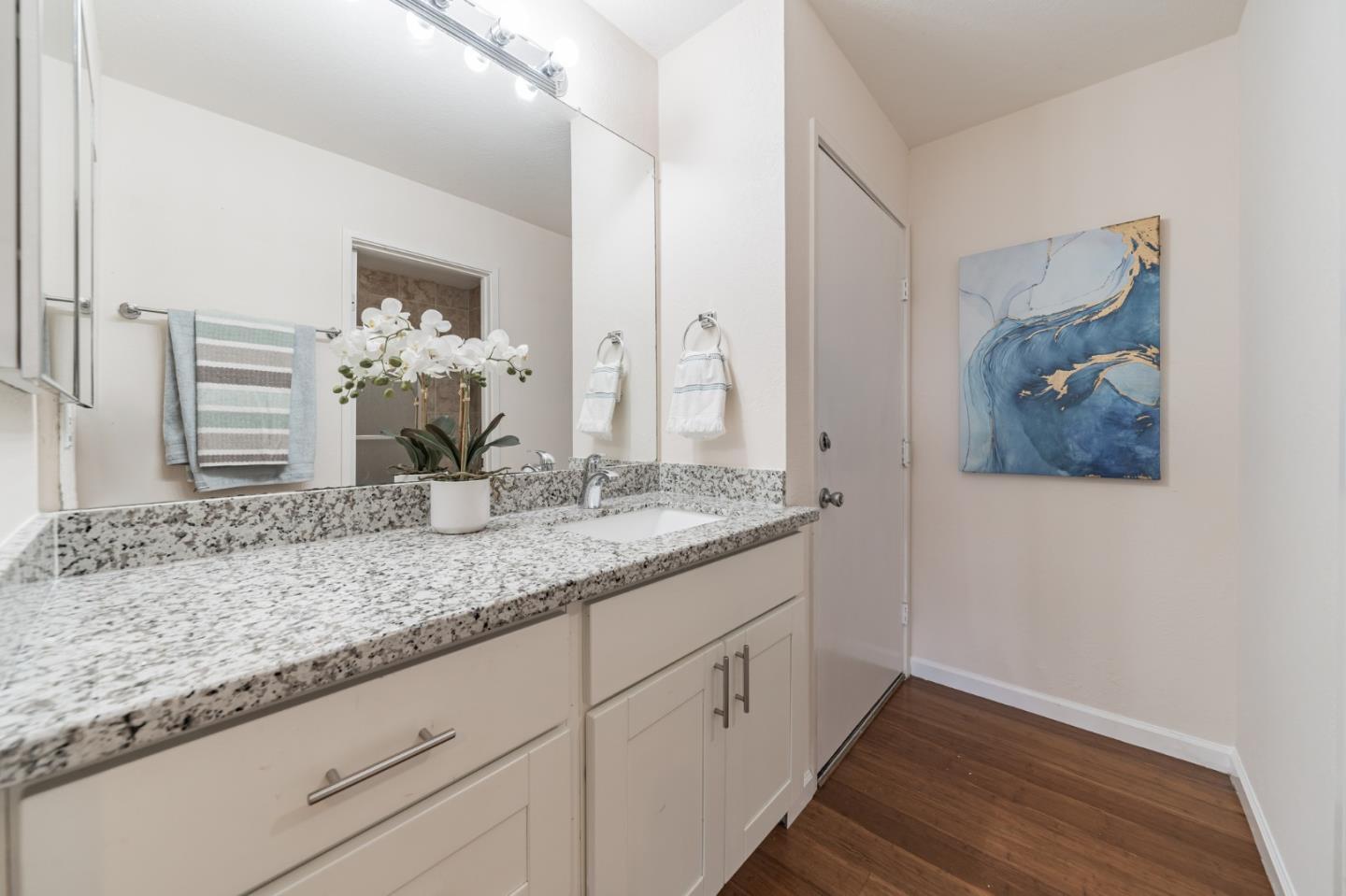 348 Innisfree Drive, Unit 60 Daly City, CA 94015 - Photo 13 of 21 a bathroom with a granite countertop sink and a mirror