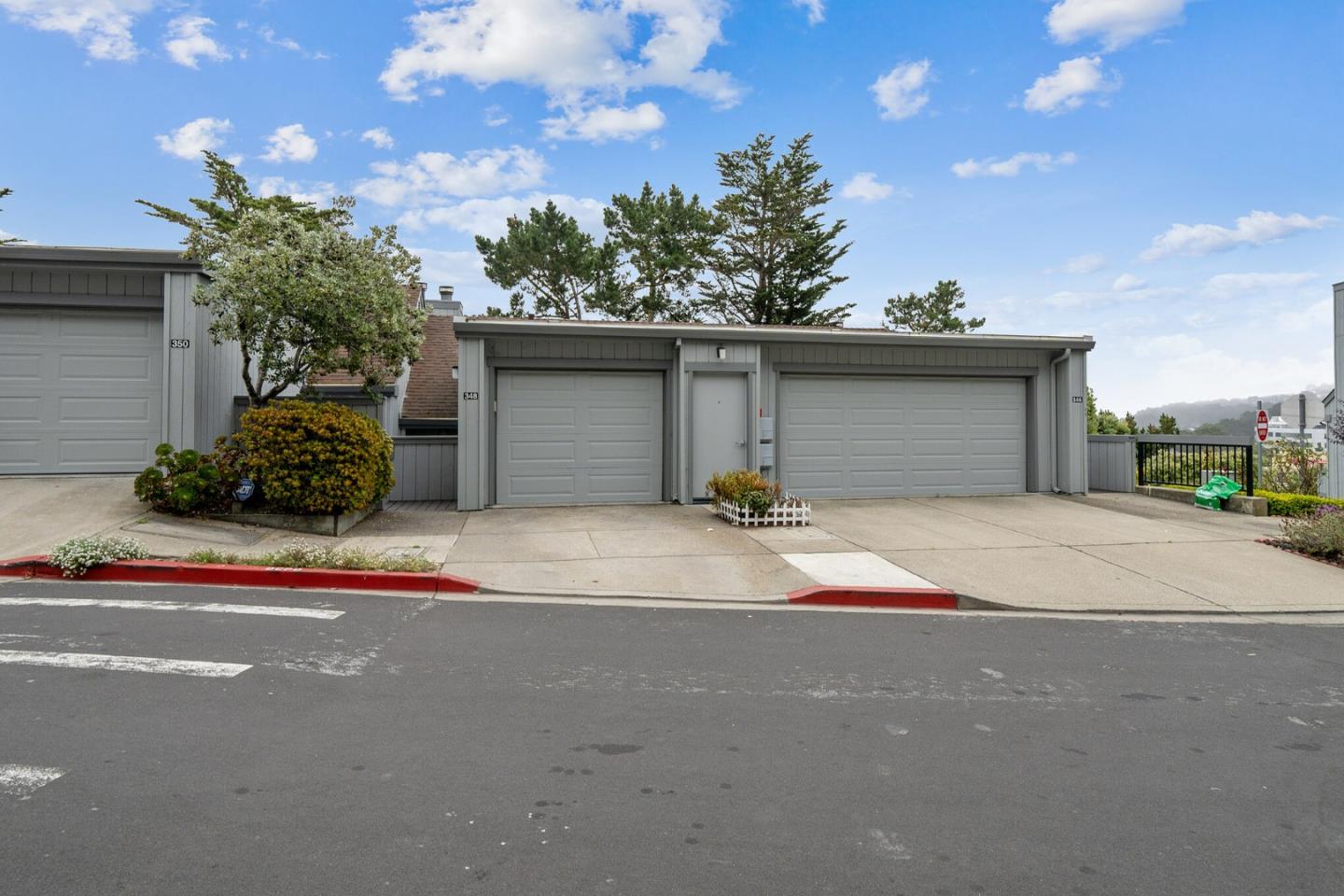 348 Innisfree Drive, Unit 60 Daly City, CA 94015 - Photo 21 of 21 a front view of a house with a yard and garage