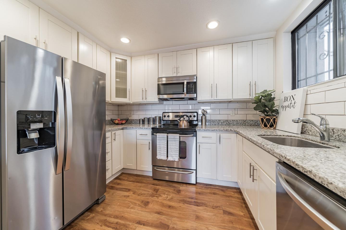 348 Innisfree Drive, Unit 60 Daly City, CA 94015 - Photo 7 of 21 a kitchen with a refrigerator sink and microwave