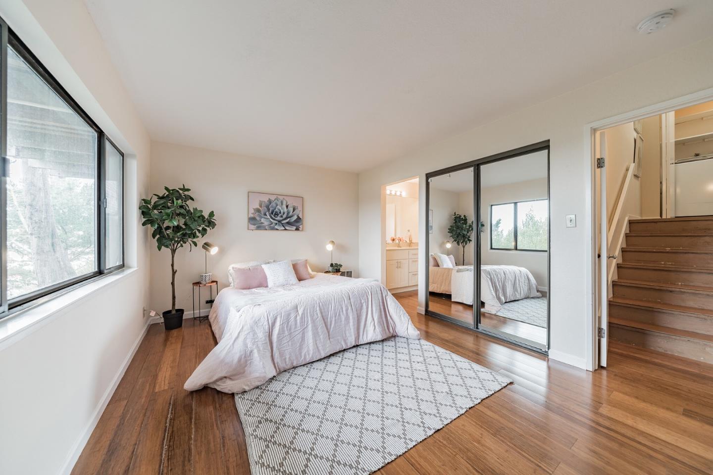 348 Innisfree Drive, Unit 60 Daly City, CA 94015 - Photo 8 of 21 a bedroom with a large bed and a chandelier