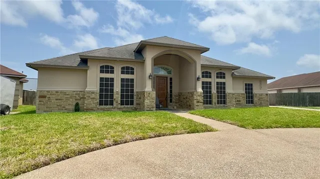 a front view of a house with garden