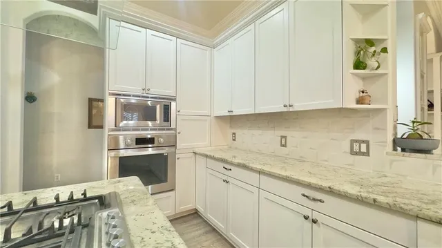 a kitchen with a sink stove and cabinets