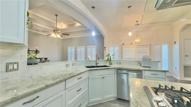 a kitchen with a sink and stove