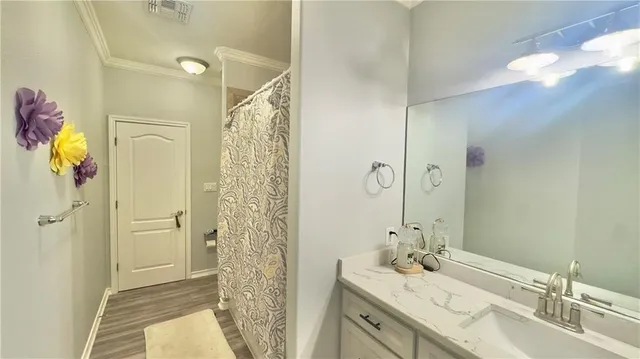 a bathroom with a granite countertop sink a mirror a shower and a bathtub