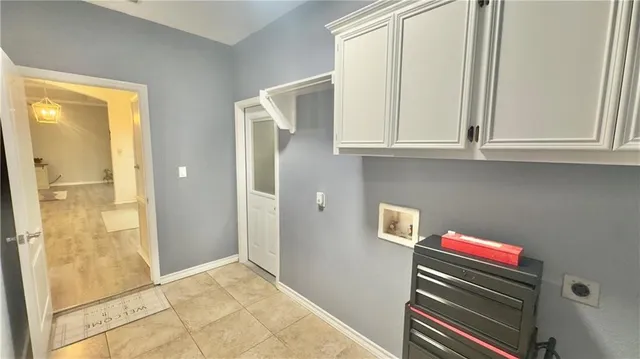 a room with wooden floor and cabinets