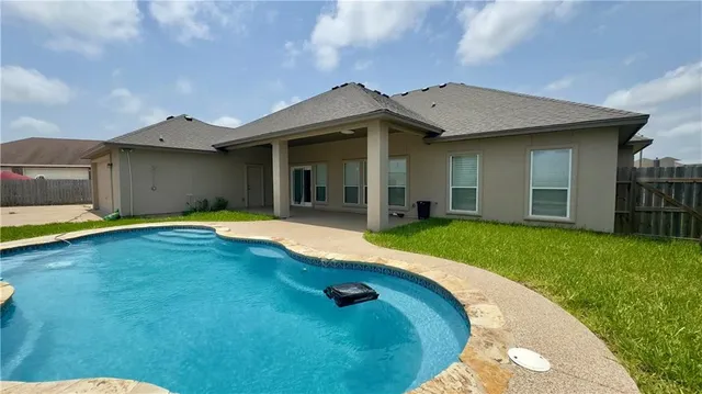 a view of a house with a swimming pool and porch