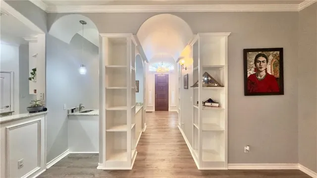 a view of a hallway with wooden floor