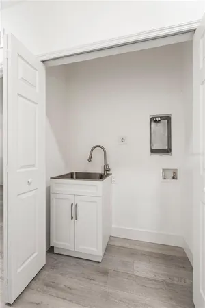 a view of a storage & utility room with a sink