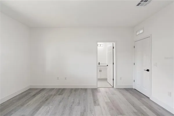 a view of an empty room and wooden floor