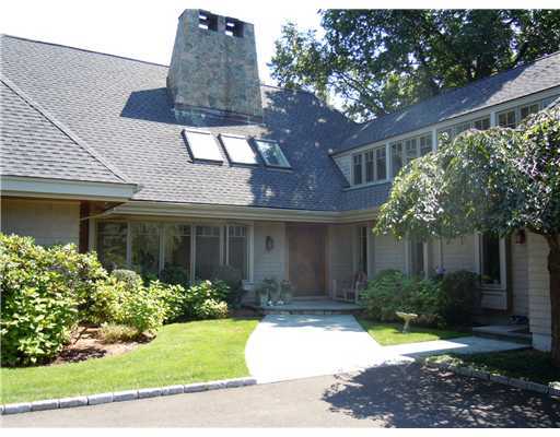 120 Cummings Point Road Stamford, CT 06902 - Photo 2 of 10 a view of a house with brick walls plants and large tree