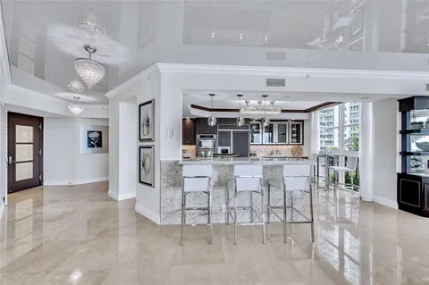a view of an dining room with furniture and chandelier