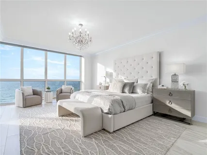 a spacious bedroom with a bed and a couch