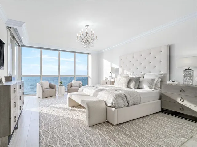 a large bedroom with a large bed and a couch