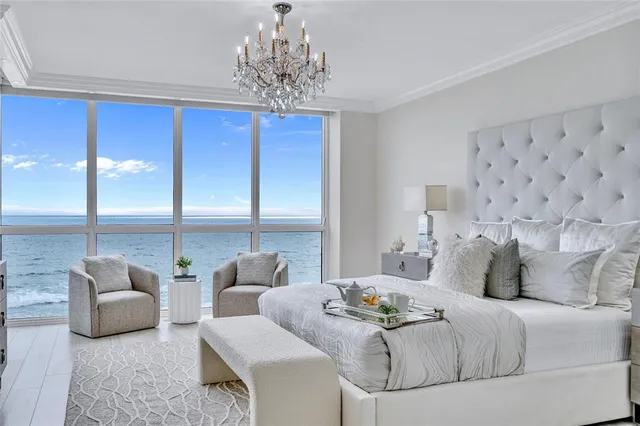 a bedroom with furniture and a chandelier
