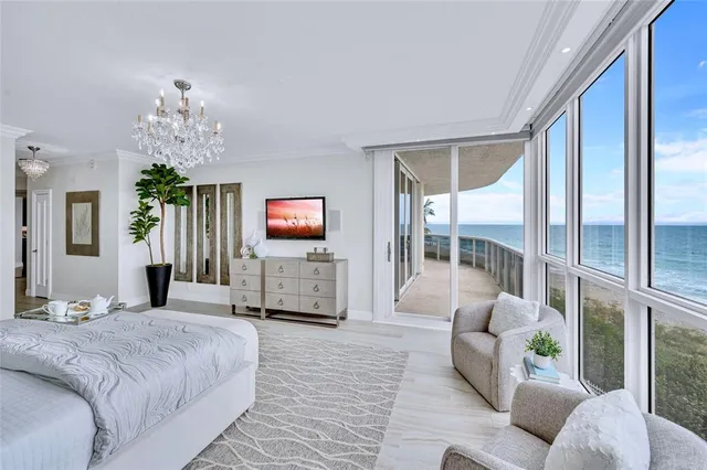 a spacious bedroom with a bed and a flat screen tv