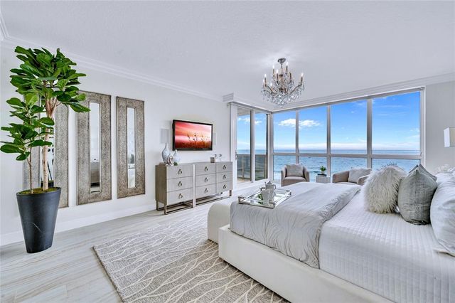 a bedroom with a balcony a bed and a television