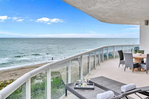 a view of a balcony with chair and wooden floor