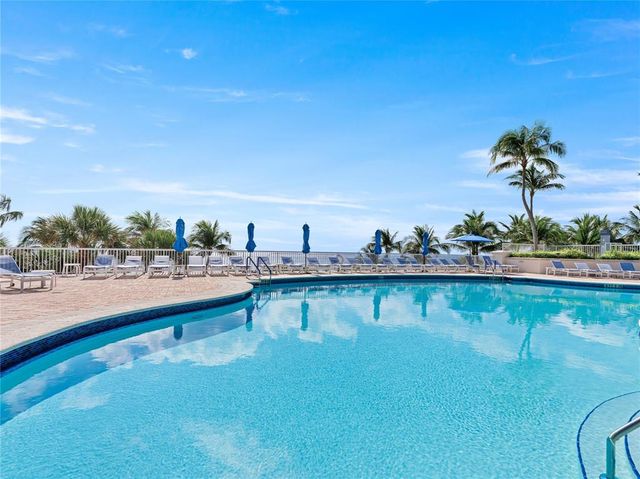 a view of a swimming pool and an outdoor seating
