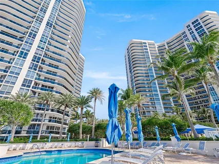 a view of a tall building next to a yard