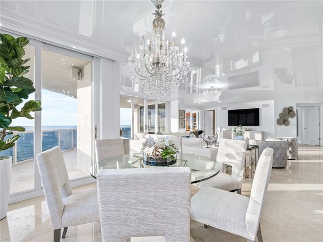 a view of a dining room with furniture wooden floor and chandelier