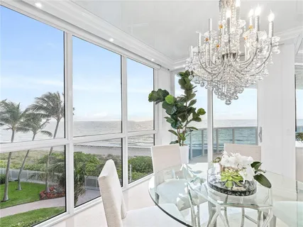 a vase of flowers sitting on a table with a glass vase