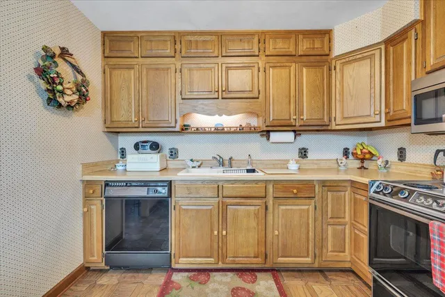 a kitchen with stainless steel appliances granite countertop a stove and a sink