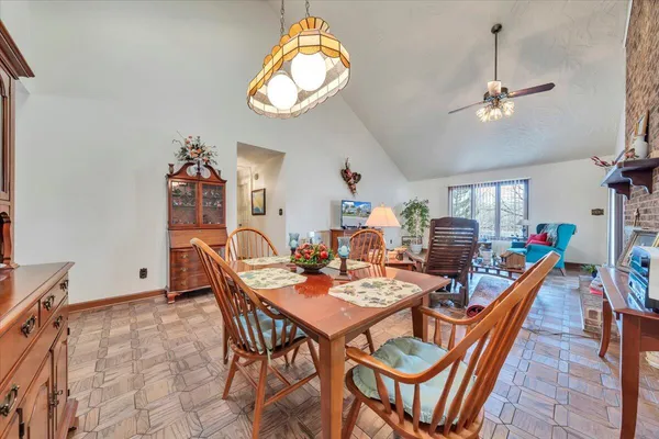 a dining room with furniture a chandelier and wooden floor