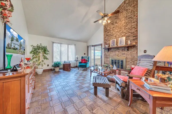 a living room with furniture a fireplace and a flat screen tv